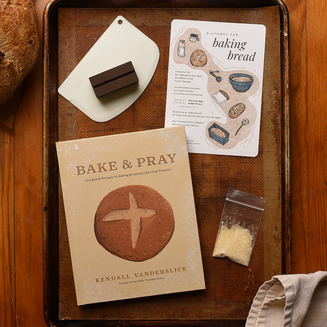 Baking items including a book titled 'Bake & Pray' on a wooden tray.